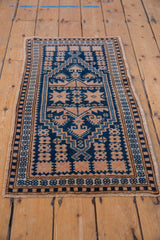 Distressed Oushak rug showing cobalt blue and ivory geometric stepped medallion with softened pile.