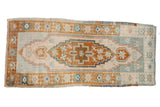 Distressed Oushak rug with ivory field, elongated bronze medallion, and pale blue patterns, 1'10