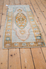 Vintage Distressed Oushak runner with artfully worn ivory, pale bronze, and soft blue patterns.