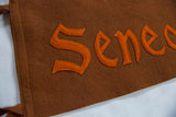 Detailed view of the hand-sewn orange letters on the antique brown felt flag.