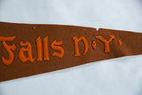 Pinholes and age-related wear on the top edge of the antique brown felt pennant.