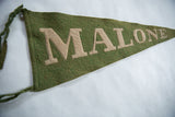 Detail of antique green wool felt banner with bold hand-sewn beige MALO letters.