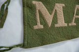 Textured green felt with prominent tan 'MA' letters, hand-stitched on vintage Malone banner.