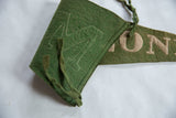Antique Malone Felt Flag showing green wool felt texture and outline stitching of letter M.