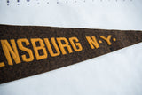 Angled detail of the gold stitched lettering on the brown wool felt Ogdensburg flag.
