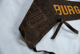 The stitched letters and brown wool ties at the end of the antique felt pennant.