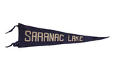 Antique blue felt pennant banner displays white 'Saranac Lake' lettering, early 20th century.