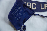 Antique Saranac Lake felt pennant showing white stitched numbers 24 and blue ties.