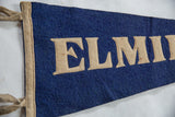 Blue felt banner with prominent beige block ELMIRA letters and side trim.