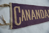 Close-up of vintage Canandaigua NY felt pennant: textured purple, cream 'CANANDA' lettering.