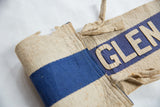 Detailed view of hand-sewn beige felt letters 