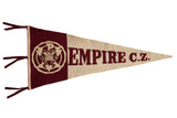 A vintage Empire C.Z. felt school pennant in maroon and cream with hand-sewn letters and emblem.