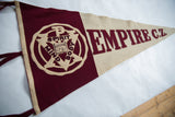 An angled perspective of the maroon and cream vintage Empire CZ felt school pennant.