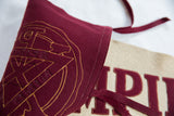 Felt texture and hand-sewn gold stitching on the vintage Empire CZ school pennant emblem.
