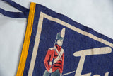 Close-up of vintage Fort Henry felt flag corner, featuring blue ties, yellow border, and soldier.