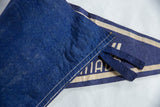 Vintage blue felt material texture with white stitched edge and loop ties.
