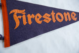 Vintage Firestone felt pennant with orange 'Fire' lettering on dark blue, orange border.