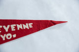 Red felt pennant's pointed tip with white 'YENNE YO-' text, showing light creasing.