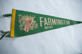 A vintage Farmington Maine pennant in green felt, shown at an angle to display its length.