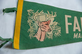 Detailed view of the 1950s buck graphic and yellow binding on the green felt pennant.
