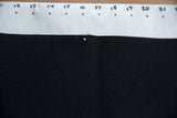 Black felt of the Princeton banner, showing a pinhole and subtle texture, with numbered ruler.