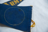 Vintage Army felt banner detail: blue fabric, yellow zigzag stitch, dark stains, felt tie.
