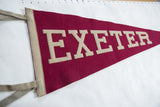 Beige felt letters spelling EXETER on a circa 1940s vintage burgundy pennant.