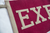 Textured burgundy felt pennant, showcasing beige 