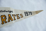 Vintage felt pennant showing orange PIRATES 1979 text and pointed tip, with light creasing.