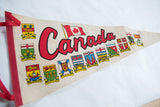 Red 'Canada' script, national flag, and colorful provincial crests on felt pennant.