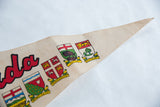 Pointed end of vintage Canada pennant, showing Prince Edward Island crest and creased felt.