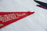 Red felt Henry Ford Museum pennant with white 'Greenfield Village' text, light creasing.