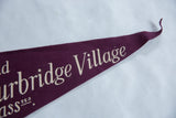 Curled tip of the deep purple felt Old Sturbridge Village pennant flag.