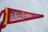 Close-up of the red felt pennant's yellow trim band and hanging ties.