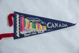 Dark blue felt souvenir pennant for Horseshoe Falls with vibrant graphic and red felt ties.