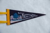 Left side detail of the vintage felt pennant, showing yellow trim and a small pinhole.