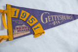 Purple felt Gettysburg pennant with yellow '1951' numbers and museum graphic.
