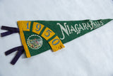 Vintage green felt pennant showing yellow '19' date detail and purple ties.