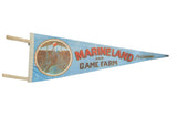 Light blue vintage Marineland Canada felt pennant with jumping Orca whale graphic.