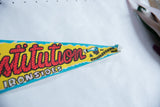 Vintage felt pennant point with red lettering, ship graphic, and light creasing.