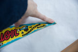 Vintage felt pennant tip in yellow and turquoise, showing 'Charlestown, Mass.' text and slight creasing.