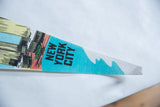 Detail of vintage felt World Trade Center pennant with 'NEW YORK CITY' and graphic.