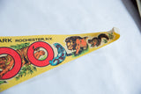 Retro graphics of blue seal, orange lion, and brown squirrel on vintage felt pennant.