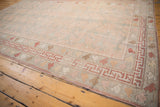 Distressed Oushak carpet showcasing rose field, allover tree of life motif, and unique banded borders.