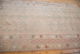 Distressed Oushak carpet detail: rose field with tree of life vinery, geometric and playful outer borders.