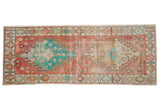 Distressed Oushak runner with faded double medallions, floral motifs, in soft red and turquoise.