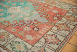 Decorative distressed texture, worn turquoise field, and coral floral border.