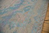 Close-up on the geometric wave border and hand-woven texture of a vintage Soumac runner.