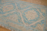 Splayed medallion and meandering vine border detail on a distressed vintage Soumac rug.