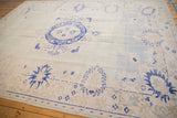 Vintage distressed Oushak rug with muted field, showcasing cobalt blue palmettes and scalloped contours.